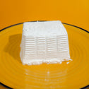 Fresh ricotta from Argiva buffalo milk placed on a yellow plate
